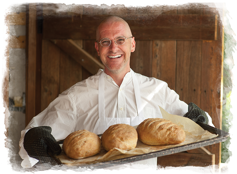 baker holding bread at zen-inspired senior living community
