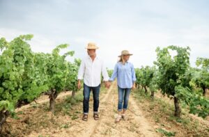senior couple walking through a vineyard