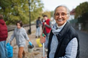 Senior woman engaging in community service outdoors